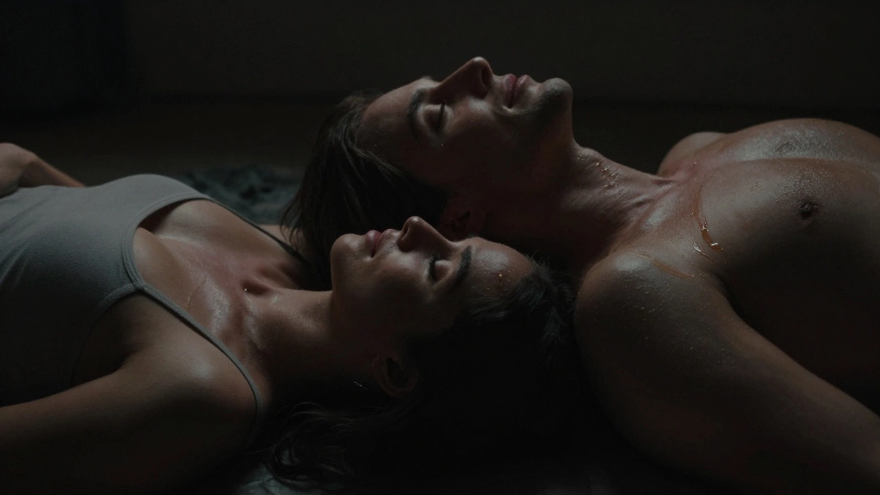 Couple lying together in darkness, faint luminescence highlighting their connected bodies.